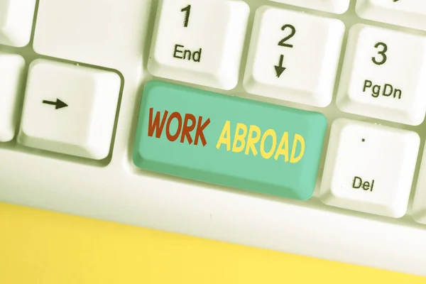 Word writing text Work Abroad. Business concept for Immersed in a foreign work environment Job Overseas Non Local White pc keyboard with empty note paper above white background key copy space. — Stock Photo, Image