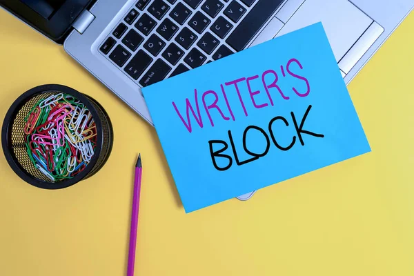 Word writing text Writer S Block. Business concept for Condition of being unable to think of what to write Trendy metallic laptop small paper sheet pencil clips colored background.