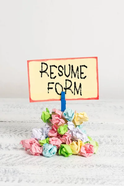 Writing note showing Resume Form. Business photo showcasing describe the layout elements appearing in written document Reminder pile colored crumpled paper clothespin wooden space.