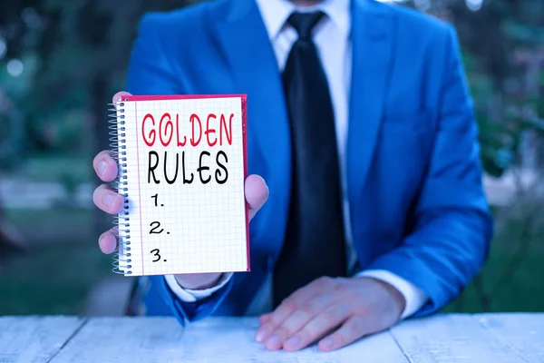 Text sign showing Golden Rules. Conceptual photo Basic principle that should be followed Important Principle Man holds empty paper with copy space in front of him.