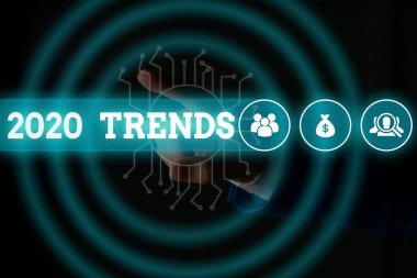 Word writing text 2020 Trends. Business concept for things that is famous for short period of time in current year Male human wear formal work suit presenting presentation using smart device.