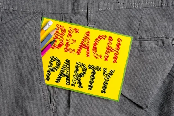 Handwriting text writing Beach Party. Concept meaning small or big festival held on sea shores usually wearing bikini Writing equipment and yellow note paper inside pocket of man work trousers.