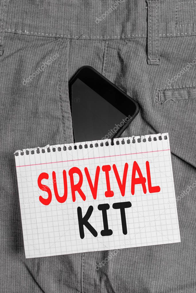 Handwriting text Survival Kit. Concept meaning Emergency Equipment Collection of items to help someone Smartphone device inside formal work trousers front pocket near note paper.