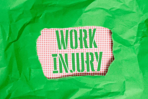 Text sign showing Work Injury. Conceptual photo Accident in job Danger Unsecure conditions Hurt Trauma Green crumpled ripped colored paper sheet centre torn colorful background.