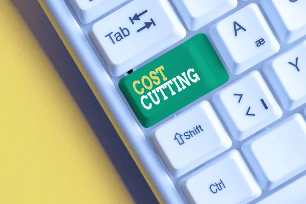 Conceptual hand writing showing Cost Cutting. Business photo text Measures implemented to reduced expenses and improved profit White pc keyboard with note paper above the white background. — Stock fotografie