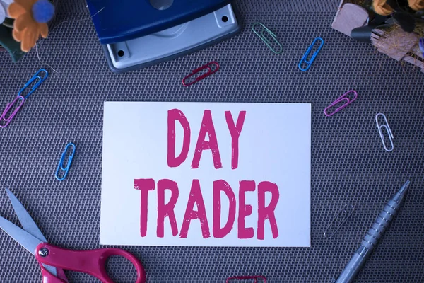 Handwriting text Day Trader. Concept meaning A demonstrating that buy and sell financial instrument within the day Scissors and writing equipments plus plain sheet above textured backdrop.