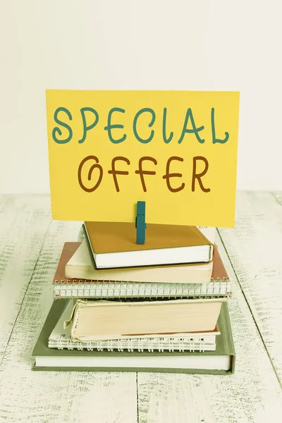 Conceptual hand writing showing Special Offer. Business photo showcasing Discounted price Markdown Promotional Items Crazy Sale pile stacked books notebook pin color reminder white wooden.