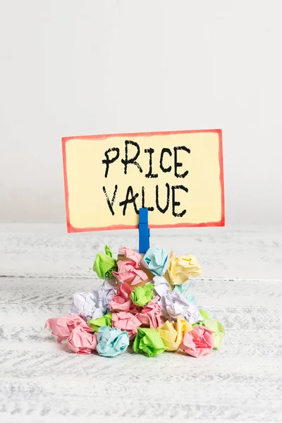 Writing note showing Price Value. Business photo showcasing strategy which sets cost primarily but not exclusively Reminder pile colored crumpled paper clothespin wooden space.