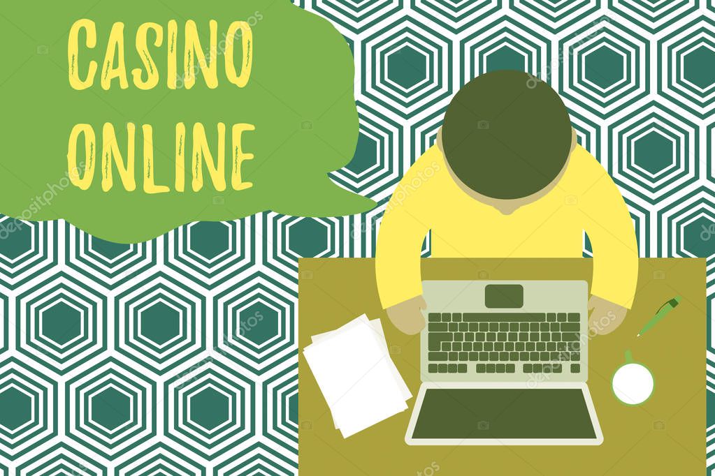 Text sign showing Casino Online. Conceptual photo Computer Poker Game Gamble Royal Bet Lotto High Stakes Upper view young man sitting working table laptop documents coffee cup pen.