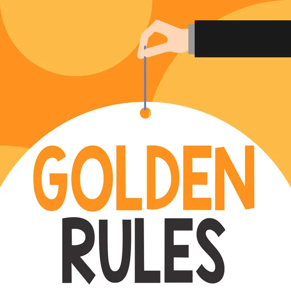 Text sign showing Golden Rules. Conceptual photo Basic principle that should be followed Important Principle Male hand arm needle punching big half blank balloon geometrical background.