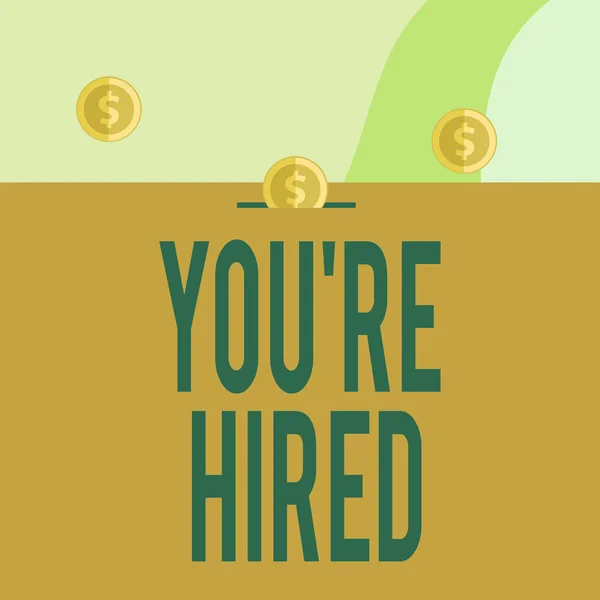 Text sign showing You Re Hired. Conceptual photo New Job Employed Newbie Enlisted Accepted Recruited Three gold spherical coins value thousand dollars one bounce to piggy bank. — Stock Photo, Image