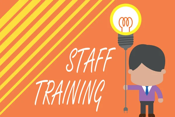 Word writing text Staff Training. Business concept for program that helps employees learn specific knowledge Standing man tie holding plug socket light bulb to connect idea. Startup.