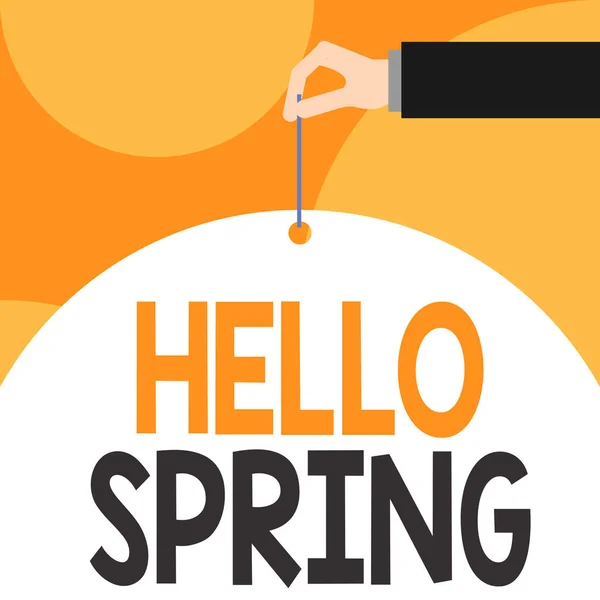 Text sign showing Hello Spring. Conceptual photo Welcoming the season after the winter Blossoming of flowers Male hand arm needle punching big half blank balloon geometrical background. — Stock Photo, Image