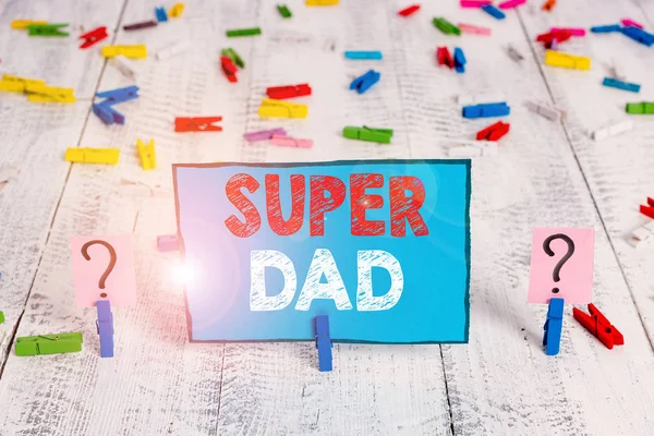 Woord tekst schrijven Super Dad. Business concept voor kinderen Idol en Super Hero een inspiratie om te kijken naar krabbelde en afbrokkelende blad met paperclips geplaatst op de houten tafel. — Stockfoto