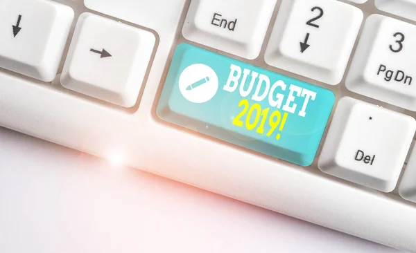 Handwriting text Budget 2019. Concept meaning estimate of income and expenditure for current year White pc keyboard with empty note paper above white background key copy space. — Stock Photo, Image