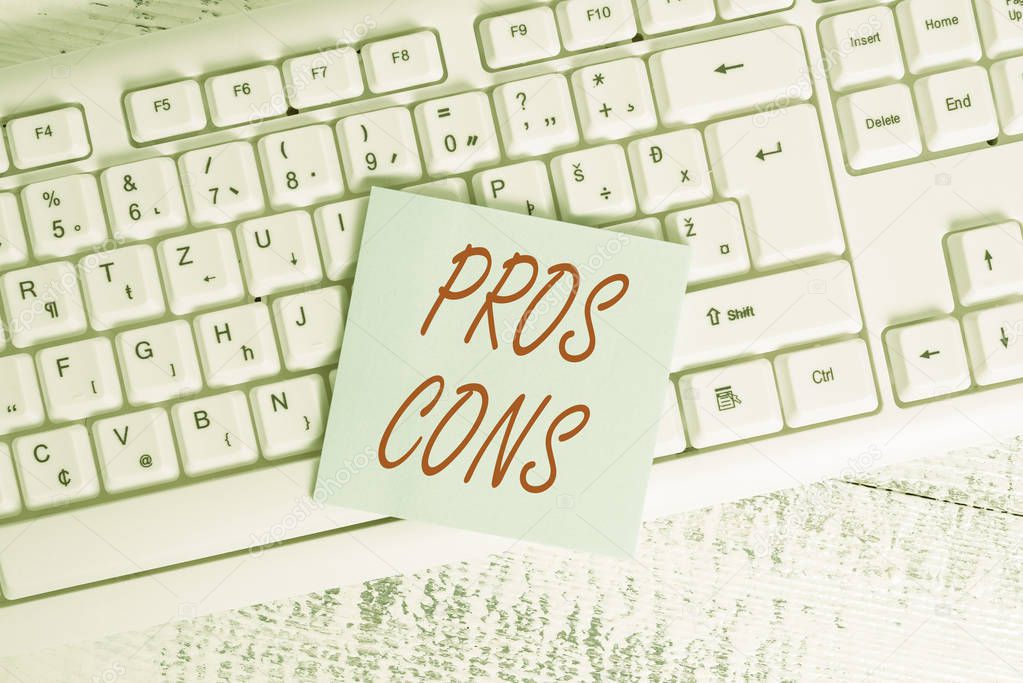 Conceptual hand writing showing Pros Cons. Business photo showcasing The favorable and unfavorable factors or reasons of demonstrating Keyboard office supplies rectangle shape paper reminder wood.