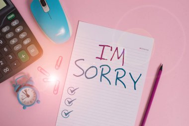Writing note showing I M Sorry. Business photo showcasing Toask for forgiveness to someone you unintensionaly hurt Calculator clips alarm clock mouse sheet pencil colored background. clipart