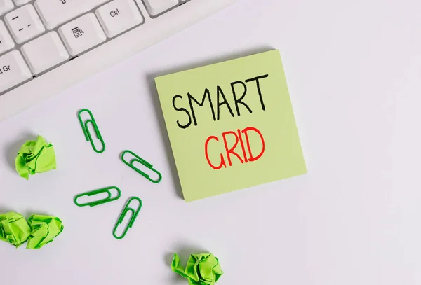 Handwriting text Smart Grid. Concept meaning includes of operational and energy measures including meters Square empty green note paper with pencil on the white background and pc keyboard.