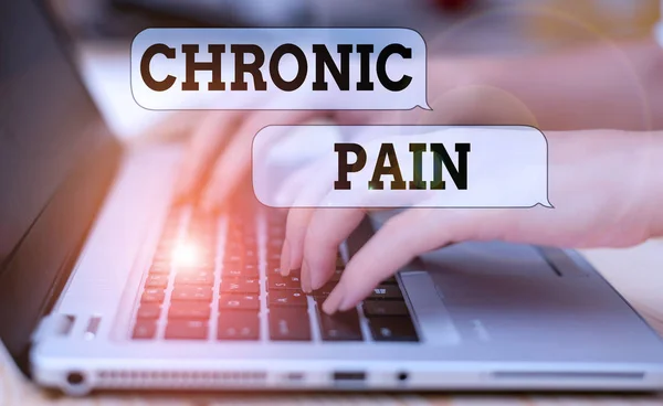 Writing note showing Chronic Pain. Business photo showcasing pain that is ongoing and usually lasts longer than six months woman with laptop smartphone and office supplies technology.