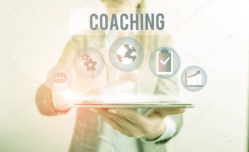 Conceptual hand writing showing Coaching. Business photo showcasing demonstrating supports client in achieving specific demonstratingal goal Female human wear formal work suit presenting smart device.