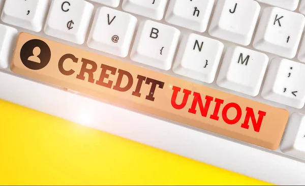 Text sign showing Credit Union. Conceptual photo cooperative association that makes small loans to members White pc keyboard with empty note paper above white background key copy space.