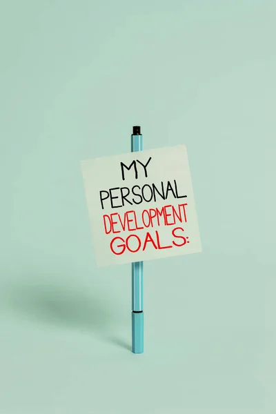 Text sign showing My Personal Development Goals. Conceptual photo Desires Wishes Career Business planning Ballpoint blank colored sticky note peaceful cool pastel fashion background.