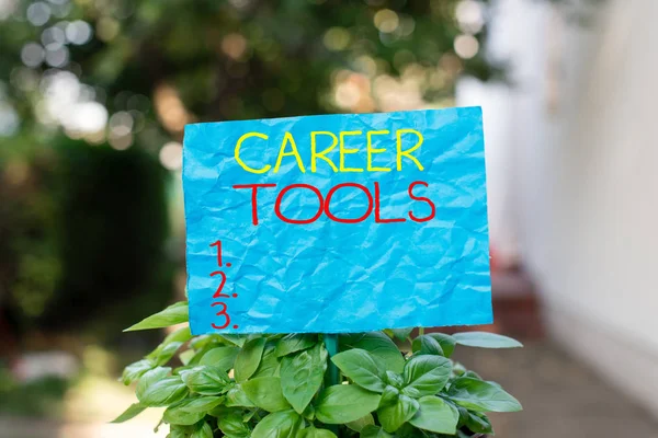 Conceptual hand writing showing Career Tools. Business photo text the system designed to assist and enhance your career Plain paper attached to stick and placed in the grassy land.