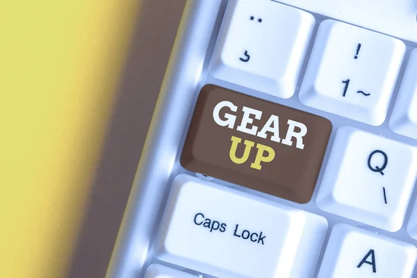 Text sign showing Gear Up. Conceptual photo Asking someone to put his clothes or suit on Getting ready fast White pc keyboard with empty note paper above white background key copy space.