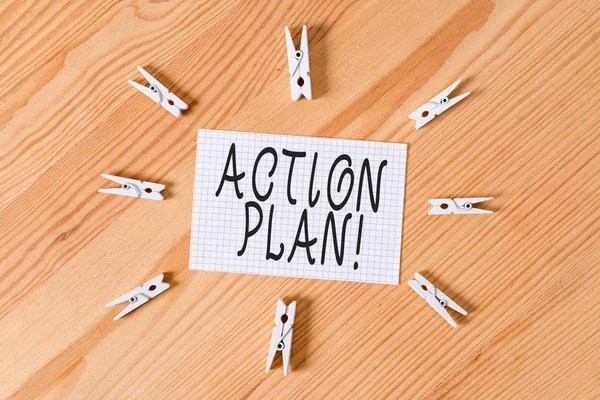 Conceptual hand writing showing Action Plan. Business photo text proposed strategy or course of actions for certain time Colored crumpled papers wooden floor background clothespin.