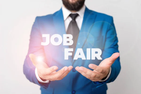 Text sign showing Job Fair. Conceptual photo An event where a demonstrating can apply for a job in multiple companies Man with opened hands in fron of the table. Mobile phone and notes on the table. — Stock Photo, Image