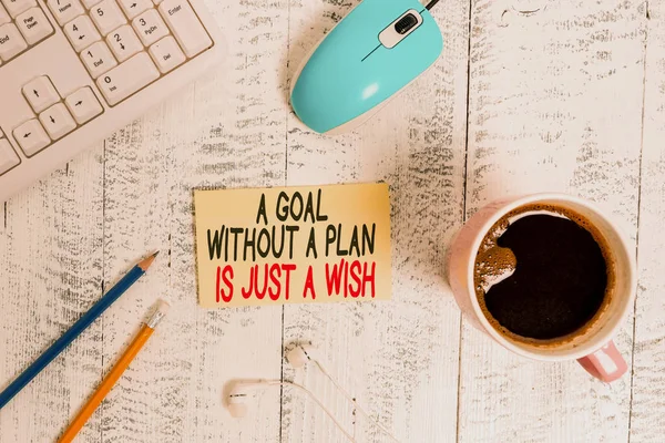 Conceptual hand writing showing A Goal Without A Plan Is Just A Wish. Business photo text Make strategies to reach objectives Technological devices colored reminder paper office supplies. — Stock Photo, Image