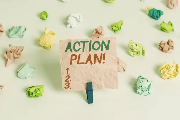 Conceptual hand writing showing Action Plan. Business photo text proposed strategy or course of actions for certain time Colored crumpled paper empty reminder white floor clothespin.