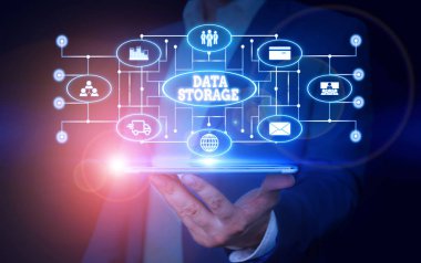 Conceptual hand writing showing Data Storage. Business photo text the act of archiving data in electromagnetic or other forms Male wear formal suit presenting presentation smart device.