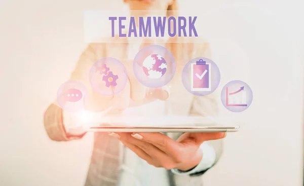 Conceptual hand writing showing Teamwork. Business photo showcasing Group of showing who work together as one and with the same aim Female human wear formal work suit presenting smart device. — Stock Photo, Image