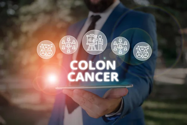 Word writing text Colon Cancer. Business concept for the development of cancer cells from the colon or rectum Male human wear formal work suit presenting presentation using smart device.