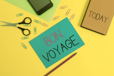 El yazısı metin bon voyage yazma. Kavram anlamı yolculuk kağıt levhalar kalem klipleri akıllı makas defter renkli arka plan yola hakkında birine iyi dileklerini ifade.