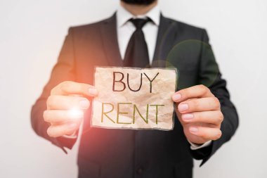 Buy Rent'i gösteren bir not yazıyorum. Bir şey satın alma veya kullanım için ödeme arasında seçim yaparak gösteren iş fotoğrafı.