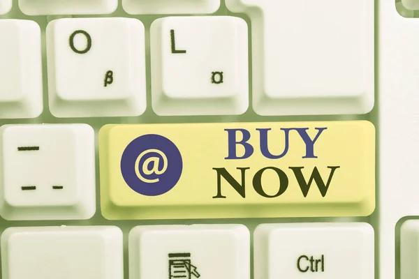 Writing note showing Buy Now. Business photo showcasing asking someone to purchase your product Provide good Discount White pc keyboard with note paper above the white background. — Stock Photo, Image