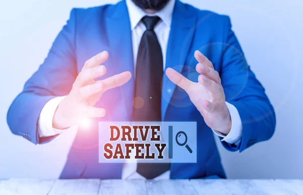 Handwriting text writing Drive Safely. Concept meaning you should follow the rules of the road and abide laws Man holds empty paper with copy space in front of him Space.