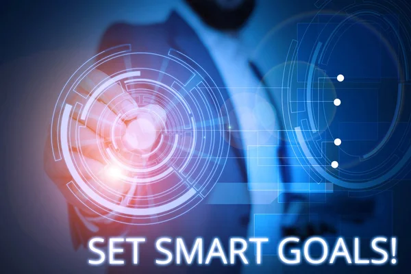 Writing note showing Set Smart Goals. Business photo showcasing list to clarify your ideas focus efforts use time wisely Male wear formal suit presenting presentation smart device.