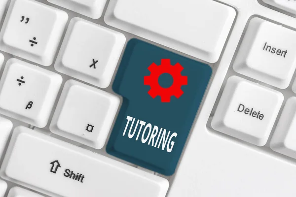 Word writing text Tutoring. Business concept for An act of a demonstrating employed to administer knowledge to someone White pc keyboard with empty note paper above white background key copy space.