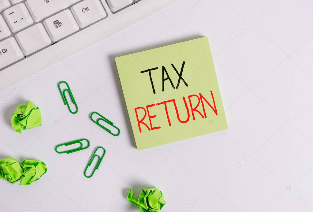 Handwriting text Tax Return. Concept meaning which taxpayer makes annual statement of income circumstances Square empty green note paper with pencil on the white background and pc keyboard.