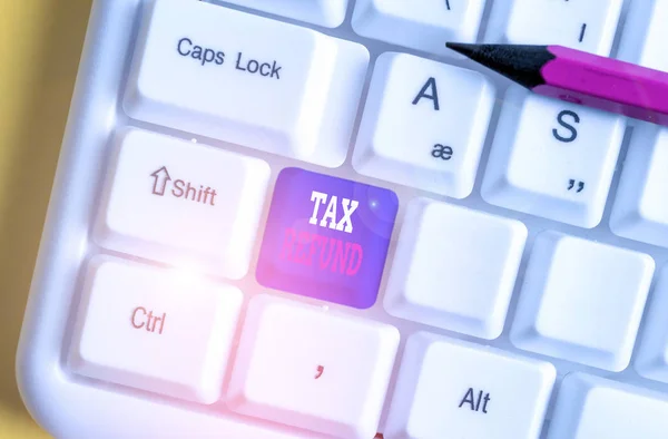 Text sign showing Tax Refund. Conceptual photo applied when money liability is less than the paid ones White pc keyboard with empty note paper above white background key copy space. — Stock Photo, Image