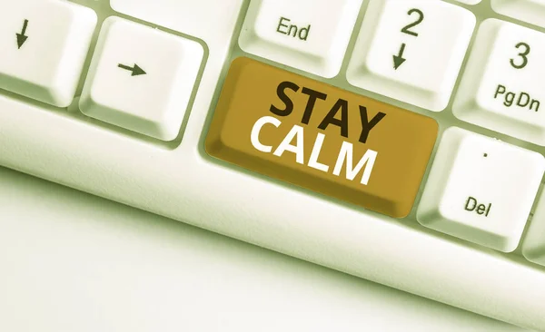 Writing note showing Stay Calm. Business photo showcasing Maintain in a state of motion smoothly even under pressure White pc keyboard with note paper above the white background. — Stock Photo, Image