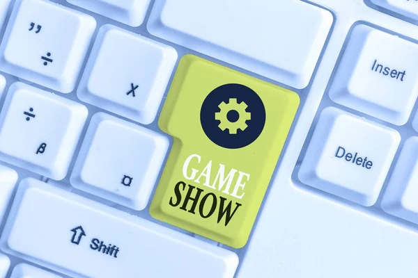 Conceptual hand writing showing Game Show. Business photo showcasing Program in television or radio with players that win prizes White pc keyboard with note paper above the white background.