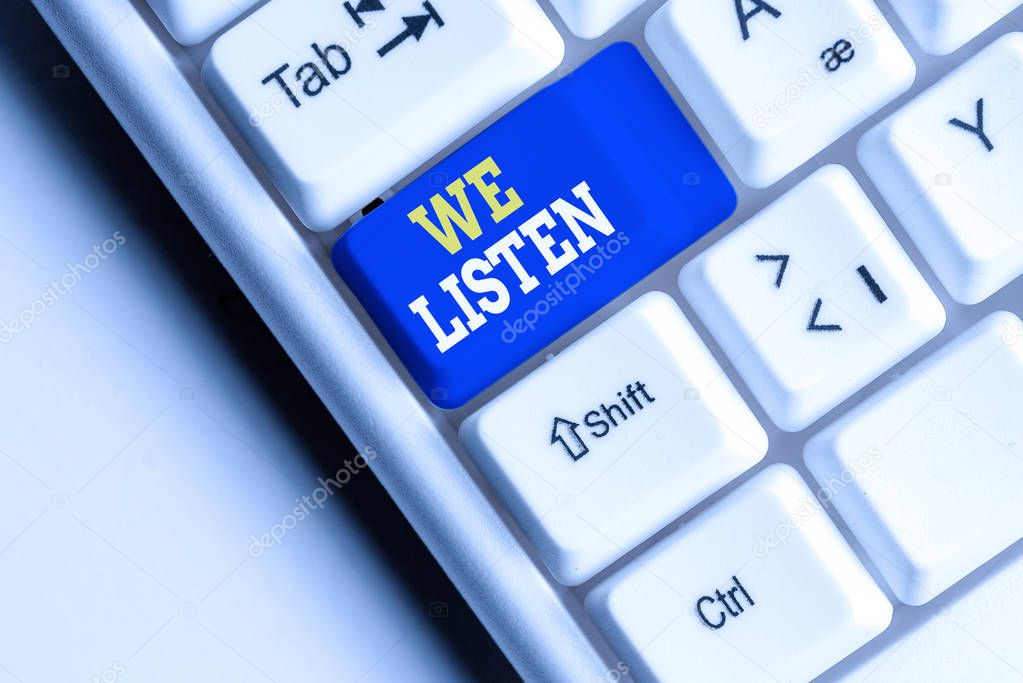 Conceptual hand writing showing We Listen. Business photo showcasing Group of showing that is willing to hear anything you want to say White pc keyboard with note paper above the white background.