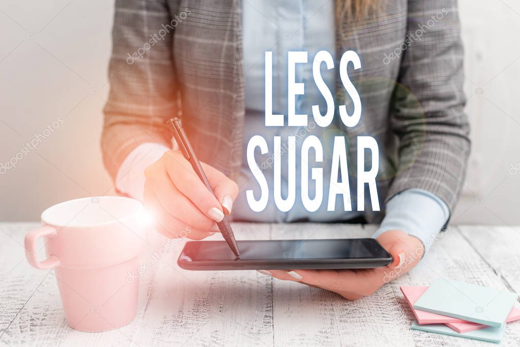 Writing note showing Less Sugar. Business photo showcasing Lower volume of sweetness in any food or drink that we eat Business woman sitting with mobile phone and cup of coffee on the table.