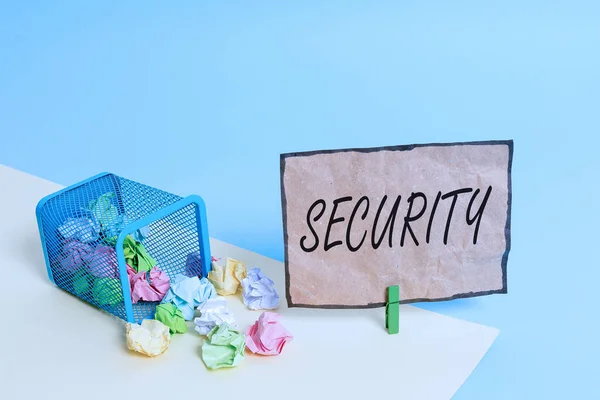 Handwriting text writing Security. Concept meaning The state of feeling safe stable and free from fear or danger Trash bin crumpled paper clothespin empty reminder office supplies tipped.