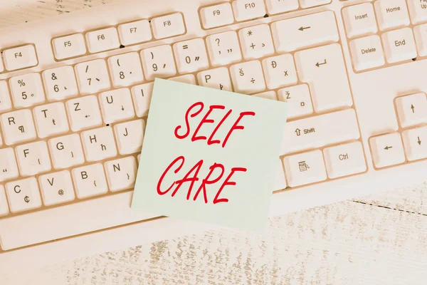 Conceptual hand writing showing Self Care. Business photo showcasing Give comfort to your own body without professional consultant Keyboard office supplies rectangle shape paper reminder wood. — Stock Photo, Image