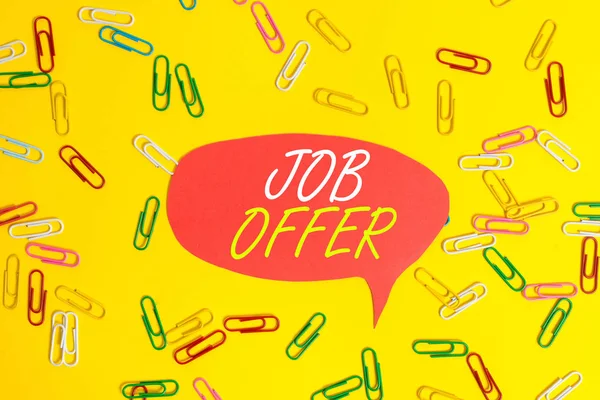 Handwriting text Job Offer. Concept meaning A peron or company that gives opurtunity for one s is employment Flat lay above empty paper with copy space and colored paper clips.